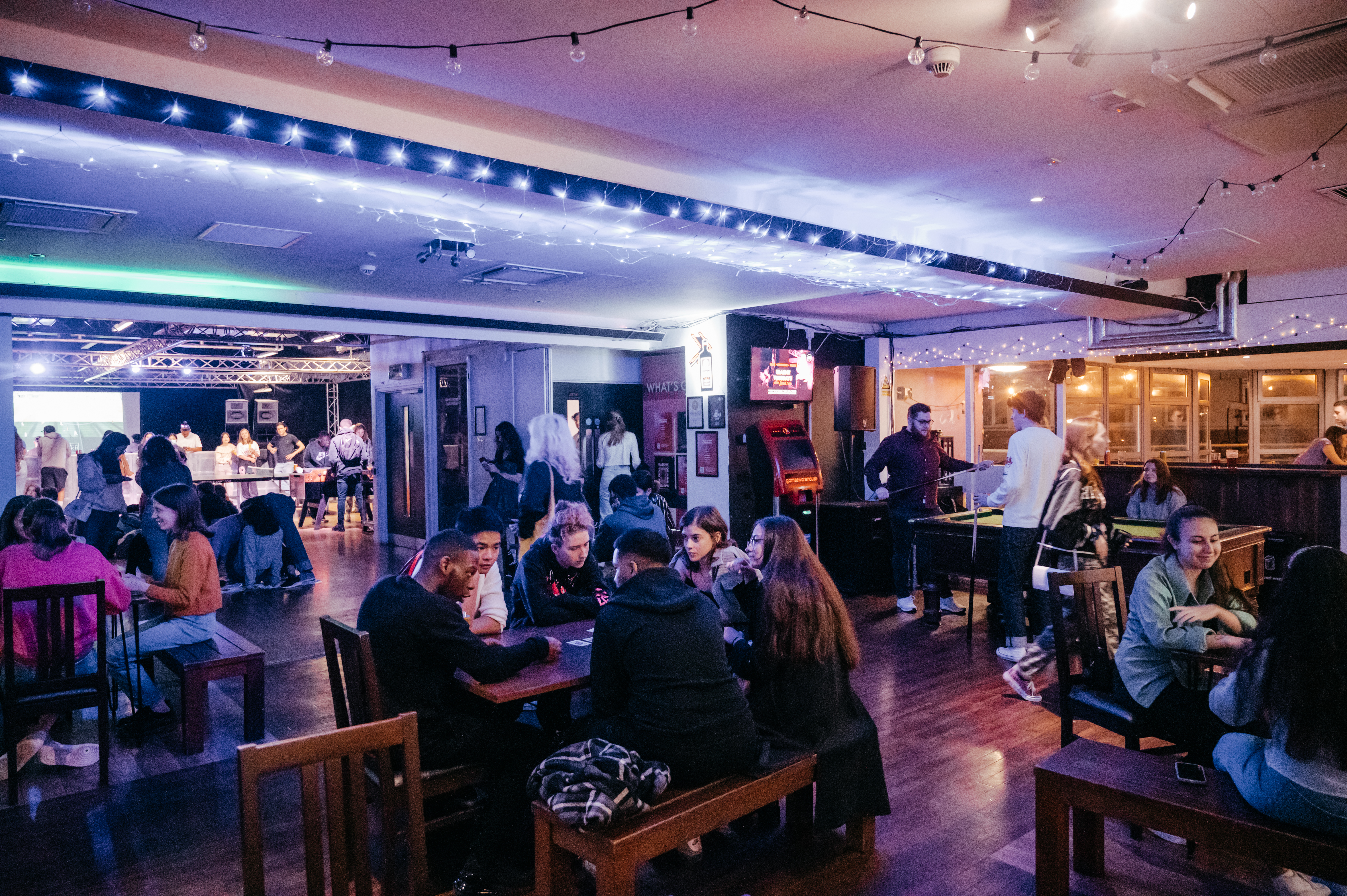 Photograph of people at a busy bar.