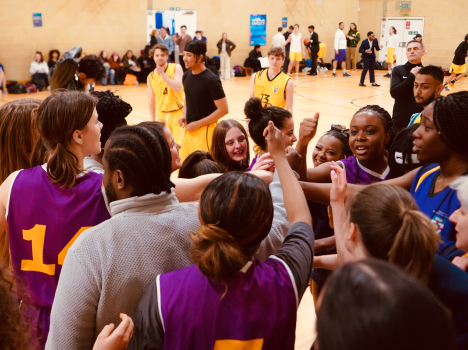 The word 'Sport' repeated over a blue-tinted photograph of a sports team